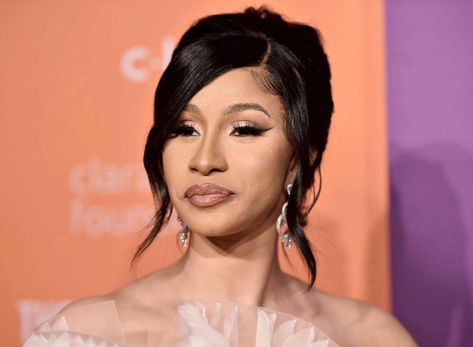 Cardi B at a red carpet event, close-up portrait